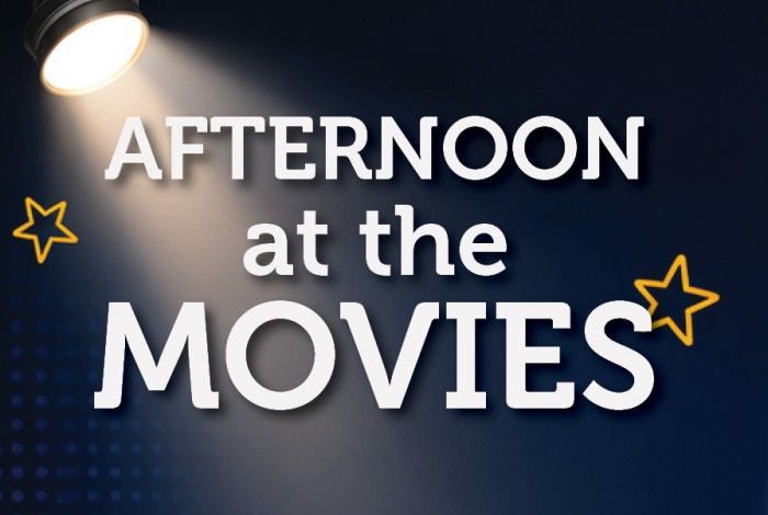 Promotional graphic for "Afternoon at the Movies" featuring large white text on a dark blue cinema-inspired background. A spotlight shines from the top left corner onto the title, with yellow star illustrations adding a playful touch.